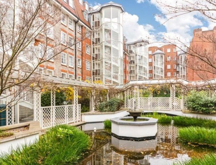 Apartment building featuring a pond and fountain