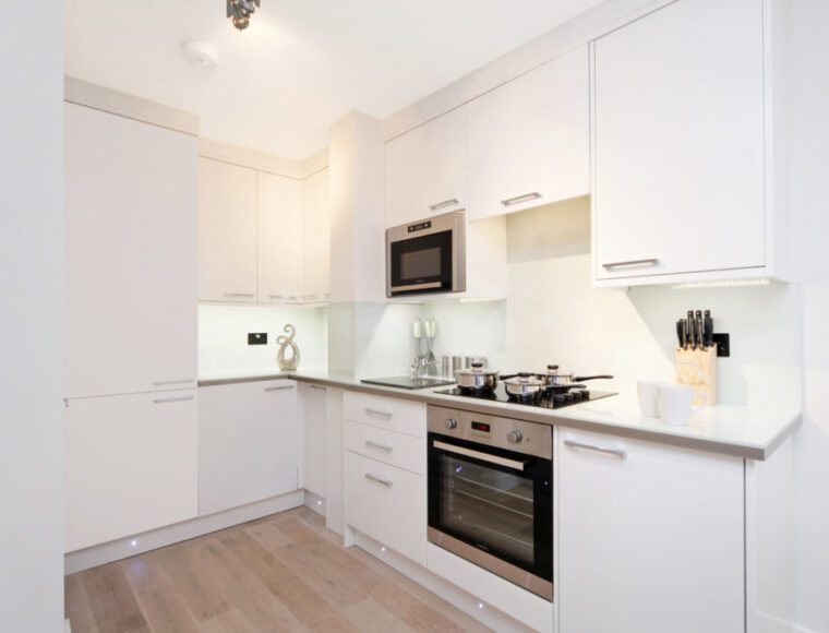 Kitchen area with a built in fridge freezer and kitchen amenities.