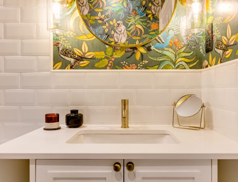 Modern bathroom with white sink and gold details