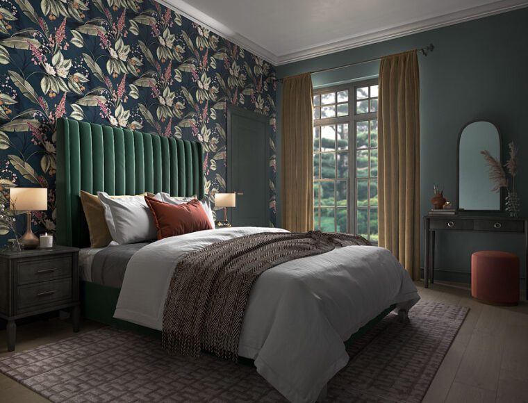 Large dark bedroom with floral wallpaper, double bed and chair.