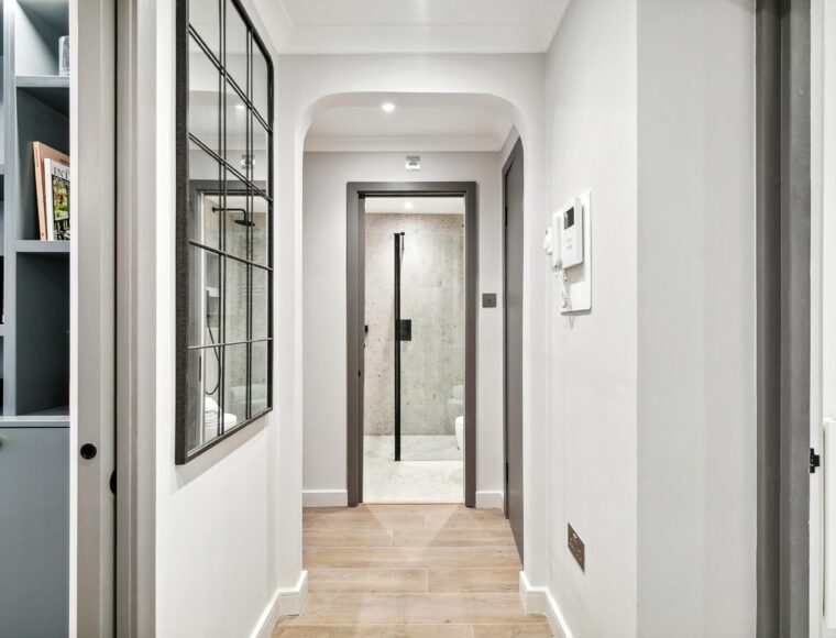 Hallway with mirror on left wall